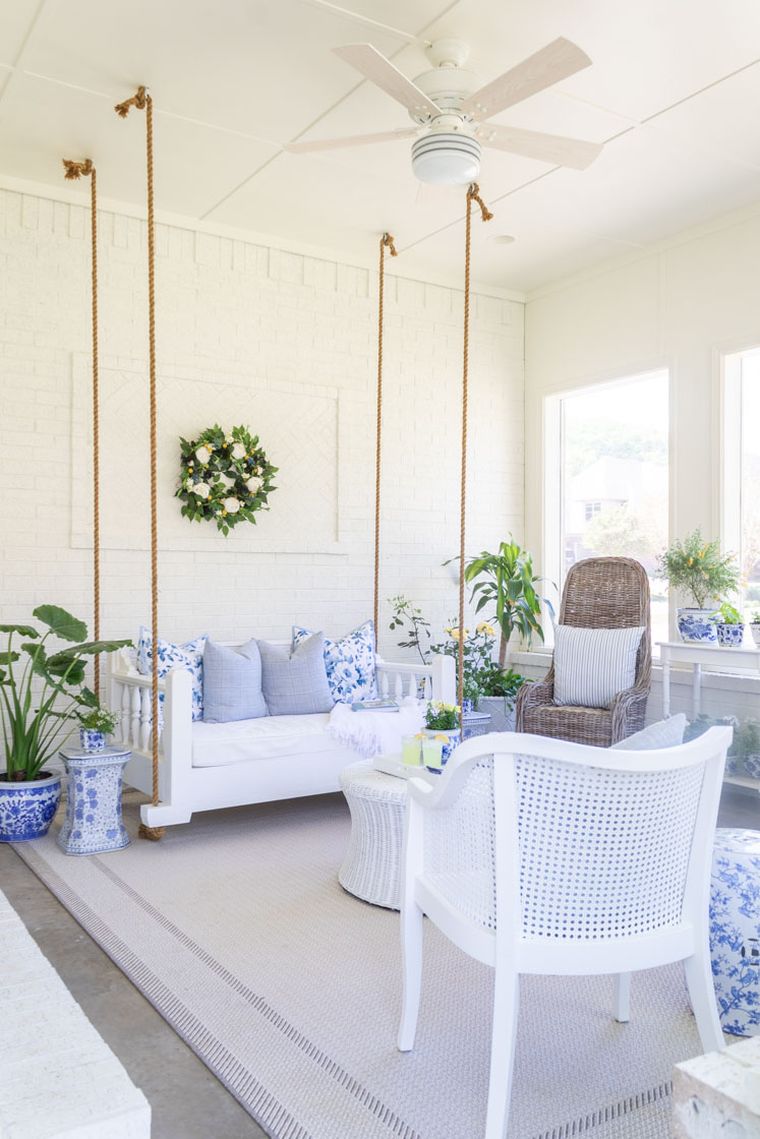 balta veranda su sūpynėmis
