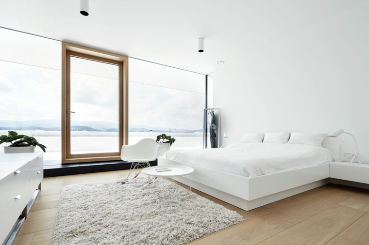 camera da letto bianca interior design testiera del letto pavimento in moquette struttura in legno