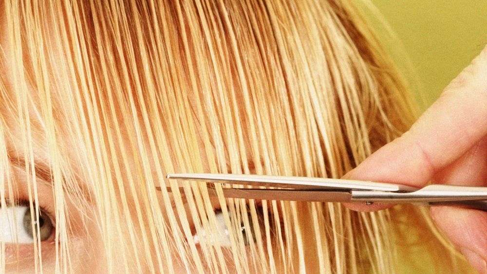 blondinės moters šukuosenos kirpimas