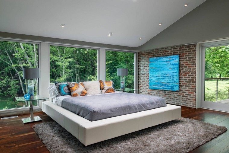 モダンなデザインのベッドのアイデアレンガの壁のカーペットの床のデコインテリア