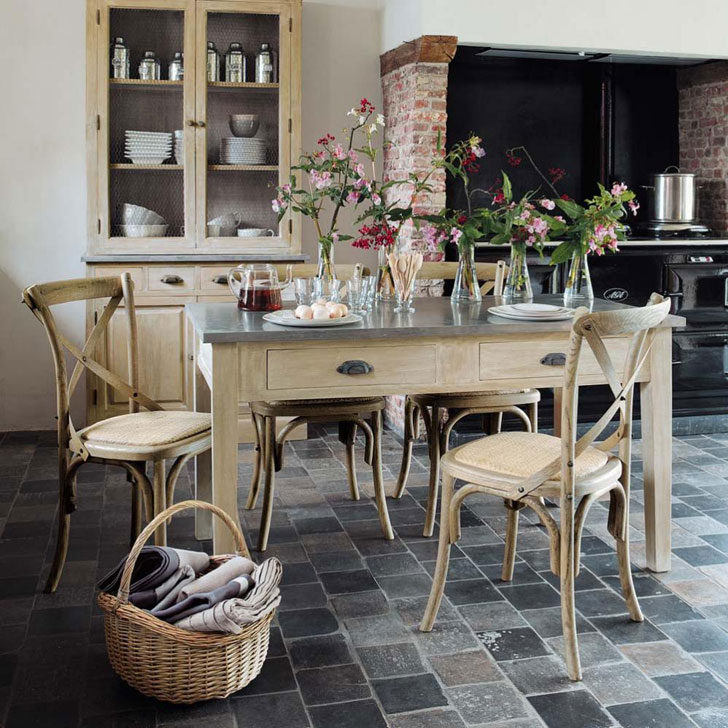 Provence tarzı mutfağın zemininde ahşap mobilyalar, sepet ve taş karolar